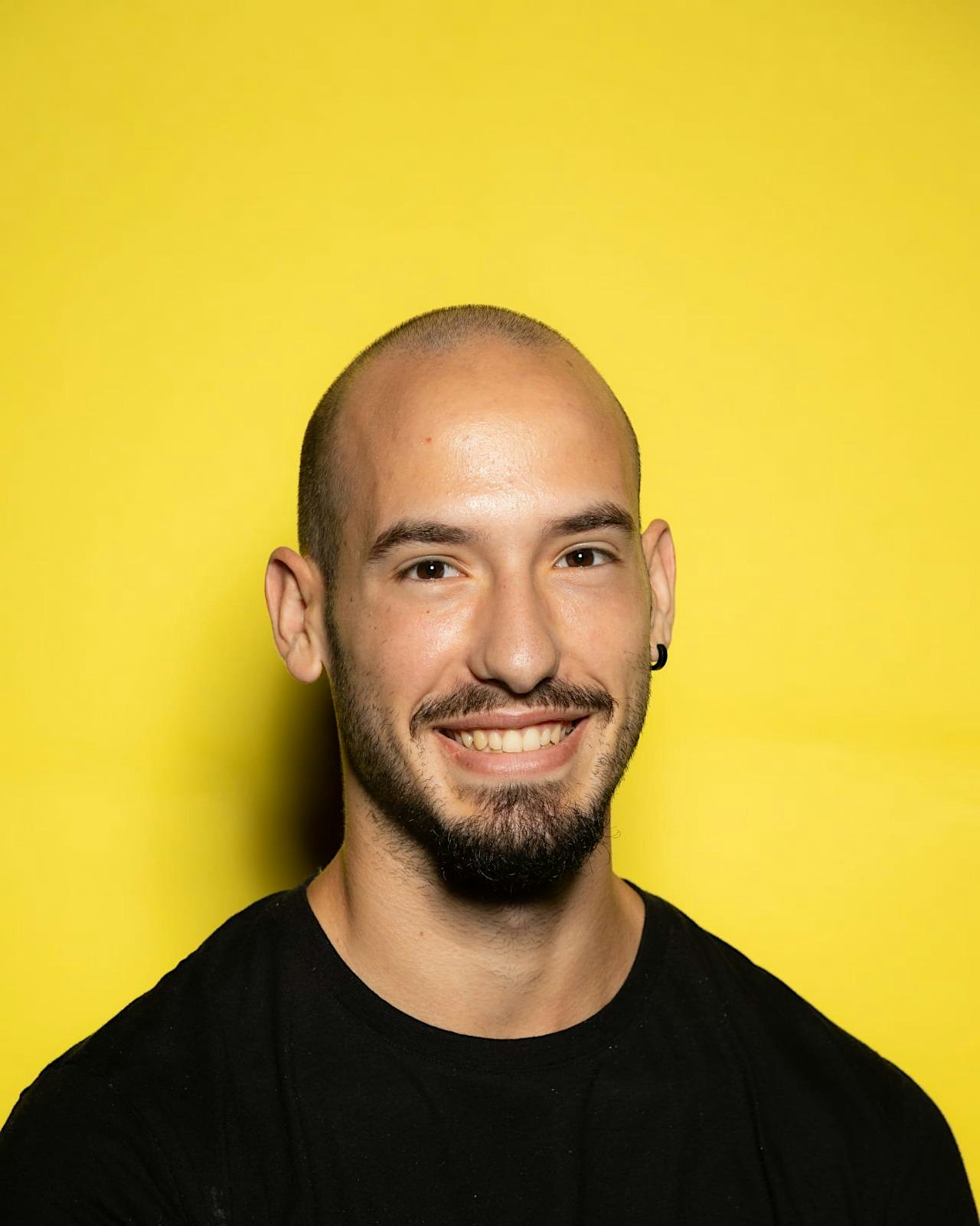 Bruno Peixoto, trainer for EGG-WORKSHOP: Design Systems, Supercharged, against a yellow background.